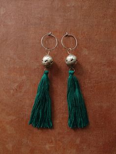 FLORES EARRINGS inspired by our trip to Guatemala. Simple, super lightweight earrings with vintage Guatemalan beads. Made from vintage handmade silver beads we found in Guatemala. Truly stunning and super lightweight (balls are empty inside).  The beads are rare finds.  Limited quantity. Adorned with Guatemalan embroidery thread tassels in lovely green shade. Anti-allergic surgical steel hoops.  approx 115mm PLEASE READ OUR SHIPPING POLICY Handmade Silver Dangle Tassel Earrings, Silver Bohemian Tassel Earrings For Festival, Silver Tassel Earrings For Festivals, Silver Tassel Earrings With Latkans For Party, Silver Bohemian Tassel Earrings With Dangling Beads, Silver Tassel Dangle Earrings, Silver Dangle Tassel Earrings With Latkans, Silver Tassel Earrings With Latkans For Gift, Silver Tassel Earrings With Latkans As Gift