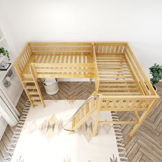 two wooden bunk beds sitting next to each other on top of a white and wood floor