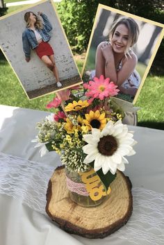 a vase filled with flowers sitting on top of a wooden table next to two pictures