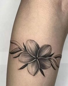 a black and white flower tattoo on the leg