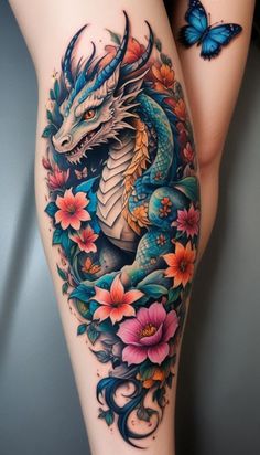 a woman's thigh with a dragon and flowers on it