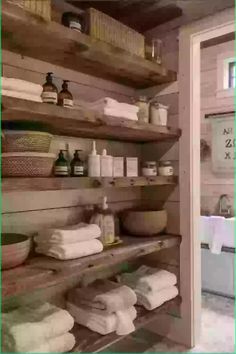 the shelves in this bathroom are filled with towels and other things to use for storage