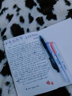 a note and pen sitting on top of an open notebook