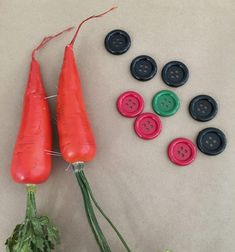 two carrots and several buttons on a table