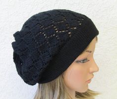 a mannequin head wearing a black knitted hat with holes on the side