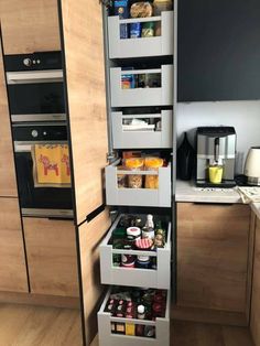 an open drawer in the middle of a kitchen