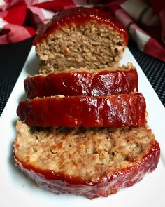 two slices of meatloaf on a white plate