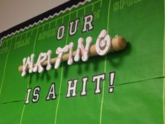 a baseball themed sign on the side of a wall that says, our waring is a hit