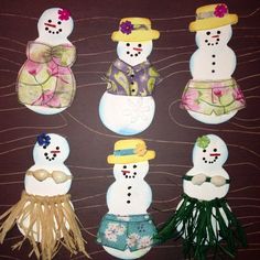 six snowmen with hats and scarfs made out of paper mache on a brown background