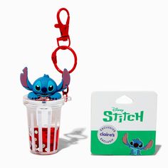 a small toy in a plastic cup with a keychain attached to it