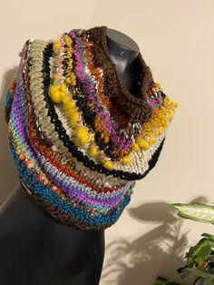 a knitted multicolored cowl on a mannequin headdress