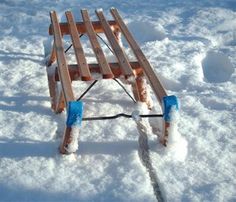 a sled with snow on it sitting in the snow