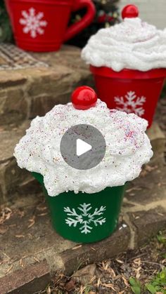 two red and green cups with white frosting on them