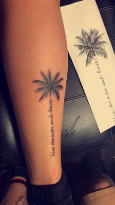 a woman's arm with a palm tree tattoo on the left side of her leg