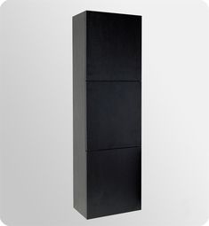 a tall black cabinet sitting on top of a white wall