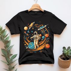 astronaut shirt, planets tshirt, colorful shirt, space themed tee, Women Shirt, Men Shirt, ot shirt, alternative shirt, gift for boyfriend shirt, gift for dad shirt BELLA CANVAS UNISEX ADULT SHIRTS DESIGN/FABRIC/CARE INFO * This updated unisex essential fits like a well-loved favorite. Super soft cotton and excellent quality print makes one to fall in love with it over and over again. * 100% Airlume combed and ringspun cotton (fiber content may vary for different colors. Solid colors are 100% cotton, heather colors are 52% cotton, 48% polyester (Athletic Heather and Black Heather are 90% cotton, 10% polyester) * Light fabric (4.2 oz/yd² (142 g/m * Retail fit, tear away label, runs true to size * Machine wash: warm (max 40C or 105F); Non-chlorine: bleach as needed; Tumble dry: low heat; Iro Tshirt Printing Design, Space Shirts, Shirts Design, Gift For Boyfriend, Boyfriend Shirt, Adulting Shirts, Men Shirt, Design Fabric, Boyfriend Tee