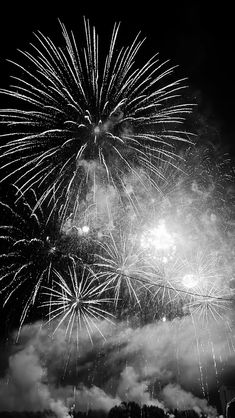 black and white photograph of fireworks in the sky