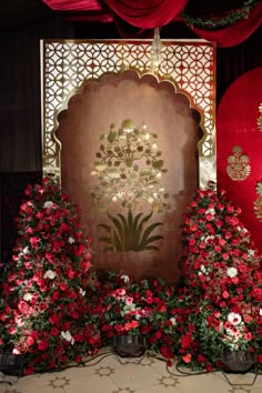 red and white flowers on display in front of a screen