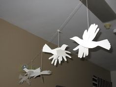 three paper birds hanging from the ceiling