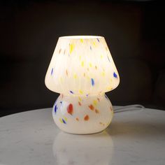 a white lamp sitting on top of a table