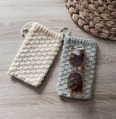 two crocheted items sitting on top of a wooden table