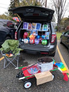 the trunk of a car is open and filled with toys