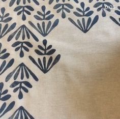 the fabric has black leaves on it