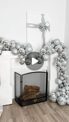 a fireplace decorated with silver christmas balls