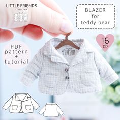 a person holding up a small white jacket on a clothes hanger with the text, little friends blazer for teddy bear