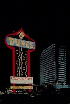 the neon sign for dunes casino in las vegas, nv is lit up at night