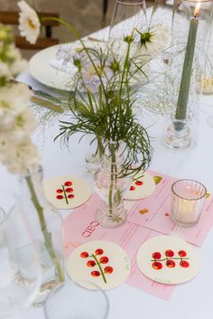 the table is set with flowers and place cards