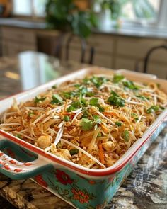 a casserole dish with shredded cheese and vegetables in it on a counter top