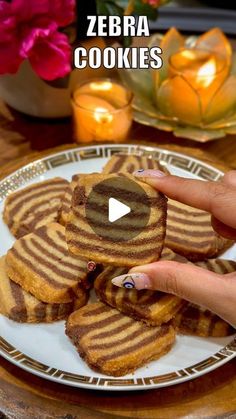 a person is holding some cookies on a plate