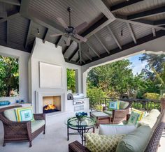 an outdoor living area with furniture and a fireplace