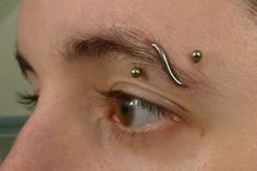 a man with two piercings on his forehead