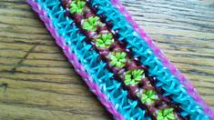 a close up of a crocheted object on a wooden table