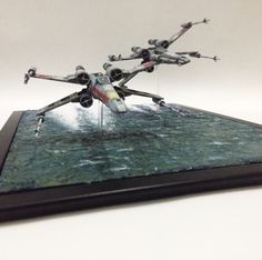 a star wars action figure is displayed on a tabletop with water splashing around it