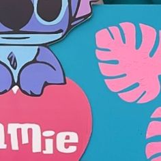 a close up of a sign on the side of a building with a cartoon character holding a heart