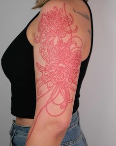 a woman with a flower tattoo on her arm