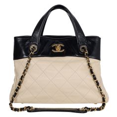 Authentic Chanel black and beige quilted leather shoulder bag. This stylish and classic tote features diamond-stitched grained calfskin leather in beige with black trim. The shoulder bag features a leather top handle, a leather-threaded gold chain-link shoulder strap, and a gold CC turn-lock closure. The bag opens to an interior with 2 large pockets, a middle zipper pocket, a side zipper pocket, and 2 slip pockets, and bottom 4 feet. Strap drop: 9.5 removable Hologram stamp reads: 16038491 Made Elegant Quilted Leather Bags, Classic Quilted Tote Shoulder Bag, Classic Quilted Tote Bag, Classic Quilted Shoulder Bag With Double Handle, Luxury Quilted Cream Shoulder Bag, Beige Quilted Leather Shoulder Bag, Elegant Quilted Beige Bag, Elegant Beige Quilted Bag, Luxury Quilted Beige Bag