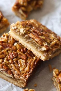 three pieces of pecan bar sitting on top of paper