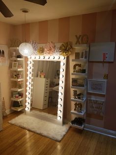 two pictures of a mirror with lights on it and shelves in the room behind them