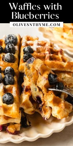 waffles with blueberries on a plate with a fork and text overlay that reads, waffles with blueberries