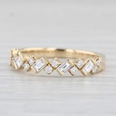 a yellow gold ring with baguets and diamonds