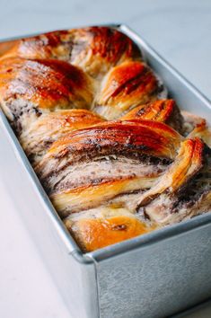 a loaf of meat and cheese bread in a metal pan