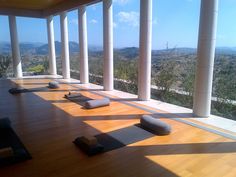 there are many yoga mats lined up on the floor in front of an open window