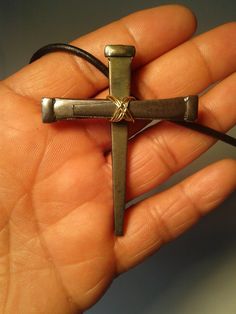 This crucifix pendant made of three steel nails serves as a visual reminder of Christ's ultimate sacrifice for mankind, and a proud statement of faith. Nail cross is approximately 2.5 inches long, 2 inches wide; total necklace length is approximately 14 inches. Handmade clasp, wire wrap bail and findings. Wire is silverplated copper with a flexible nylon coating. Because these are handmade, each cross pendant may vary slightly from the picture shown.  A wonderful gift for Easter, baptisms, First Communion, or Confirmation. Nail Cross Necklace, Wire Crosses, Nail Cross, Steel Nails, Metal Projects, Wire Wrap, Necklace Length, Cross Pendant, Pendant Necklaces