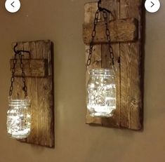 two mason jars are hanging on the wall