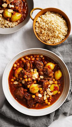 two bowls filled with stew and rice on top of a white table cloth next to another bowl