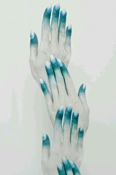 three hands with blue and white painted on them